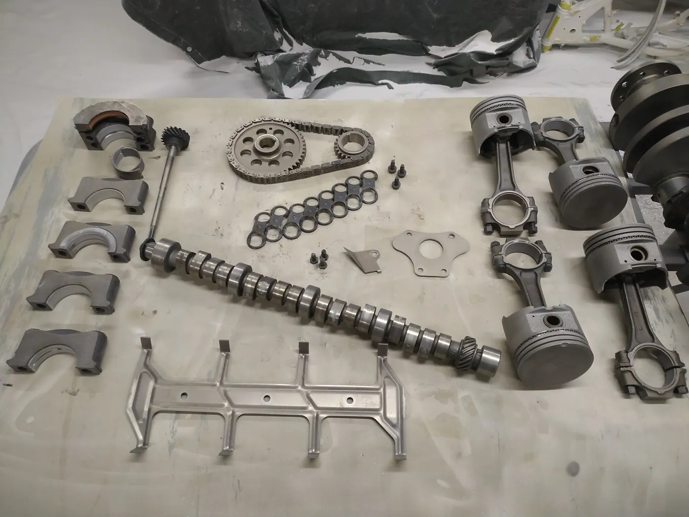 Pièces de moteur nettoyées : arbre à cames, pistons, chaîne de distribution