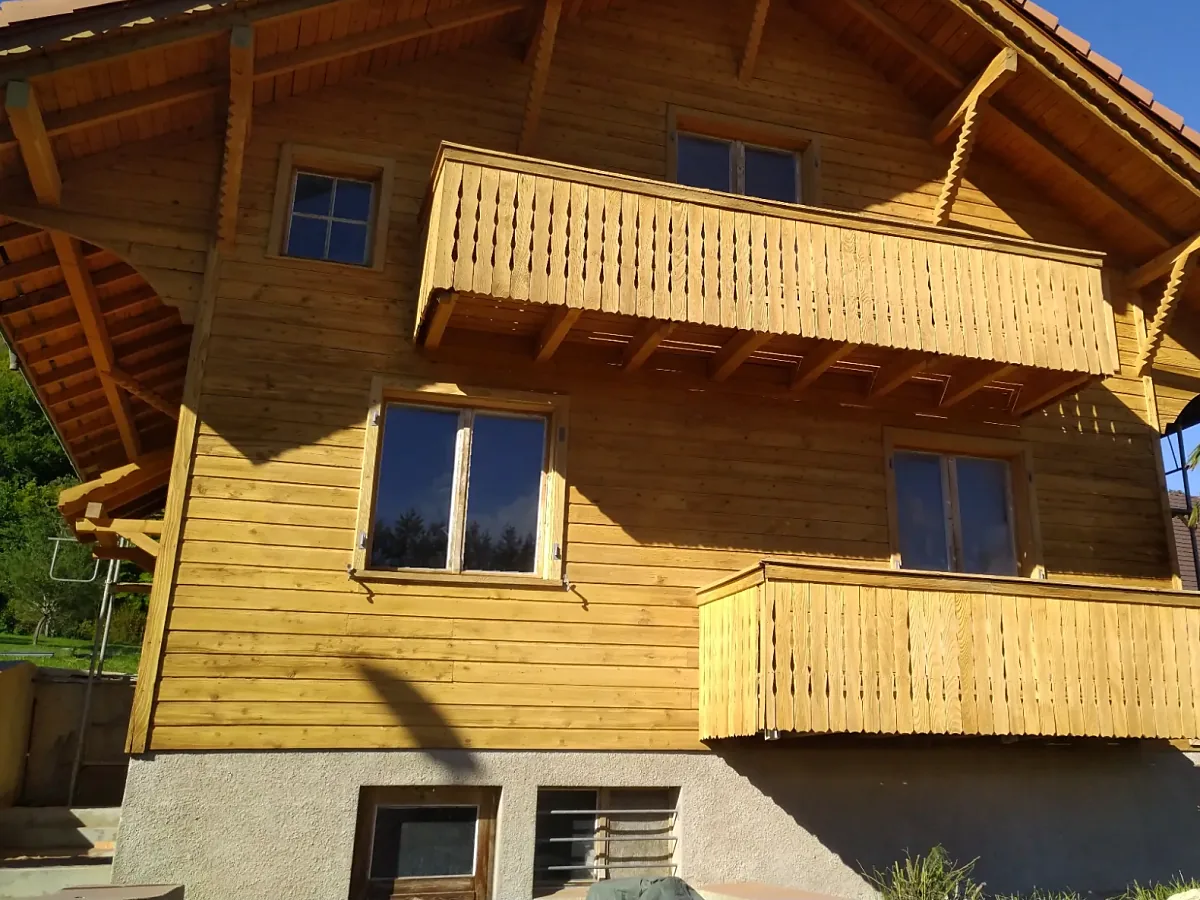 La même façade de chalet après aérogommage, bois clair et blond retrouvé